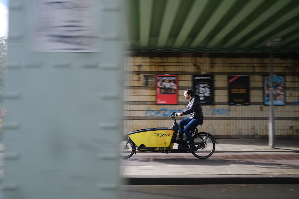 Cargoroo bike in motion under a city bridge